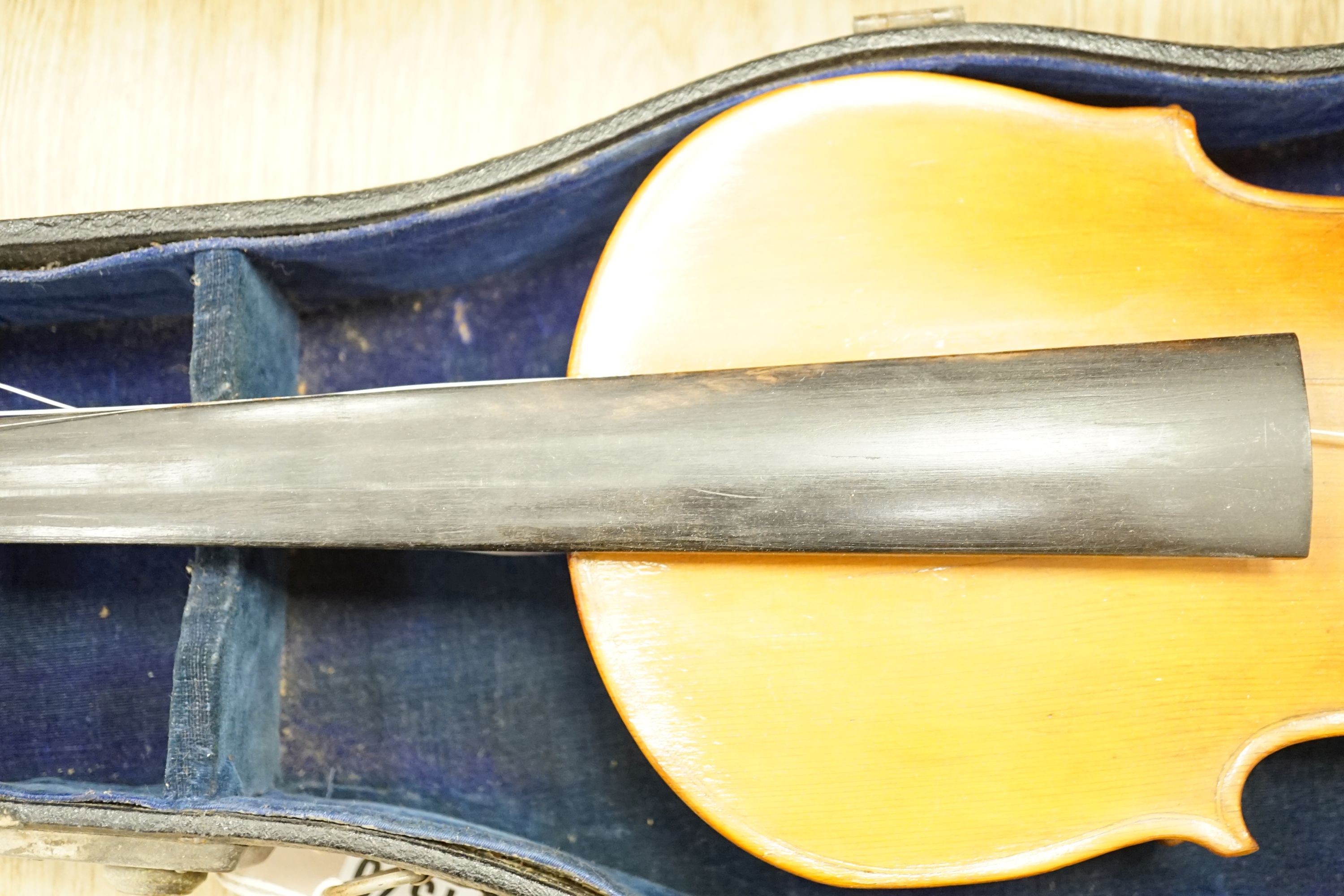 A cased violin, 60 cms long.